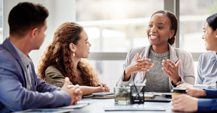 Discussion, meeting and business people in office for teamwork, planning or review at table. Collaboration, professional and group of diverse employees for ideas, conversation or project development.